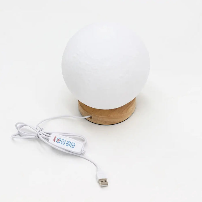 New wave lamp moon is a white spherical lamp with a wooden base and usb charging cable for easy use