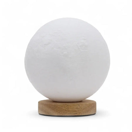 New wave lamp moon is a white spherical lamp with a textured surface resting on a wooden base