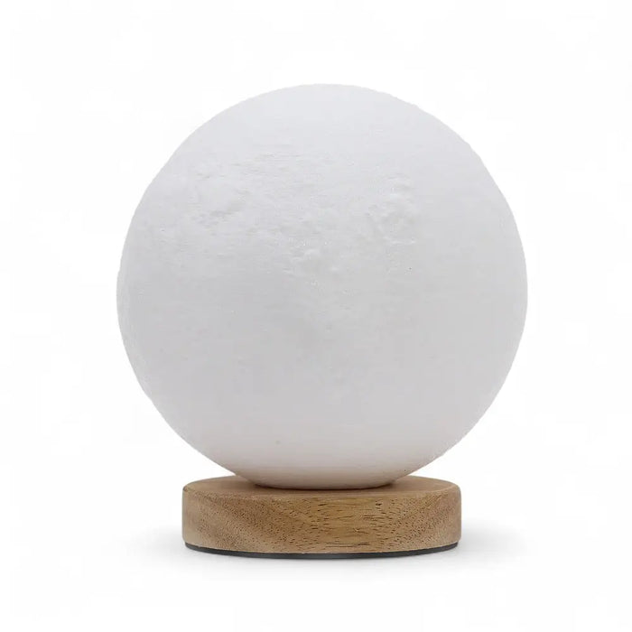 New wave lamp moon is a white spherical lamp with a textured surface resting on a wooden base