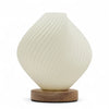 Cream-colored ribbed glass new wave lamp shell twisted with a wooden base for stylish home lighting