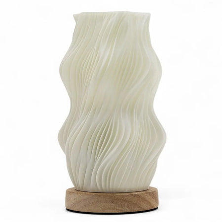 New wave lamp star twisted with cream ceramic wave pattern and natural wood base on a plain background