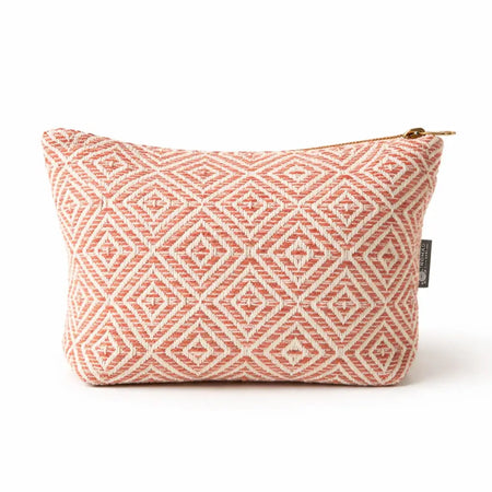 A coral maze jacquard toiletry bag with cream geometric weave and gold zipper for travel or daily use