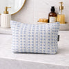 A light blue and white indigo echo toiletry bag with textured Indian jacquard fabric and a subtle floral pattern