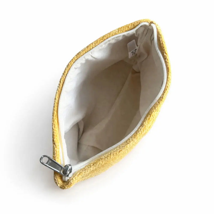 A cozy mustard-yellow jacquard toiletry bag with silver zipper and white lining for everyday essentials by marigold loom