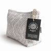 Gray jacquard toiletry bag with woven moonlit weave pattern and nomad sari black tag for travel use