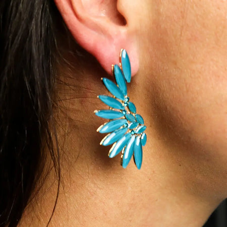 Teal green nymph aurora glass earrings shaped like angel wings with turquoise feather and gold toned metal accents