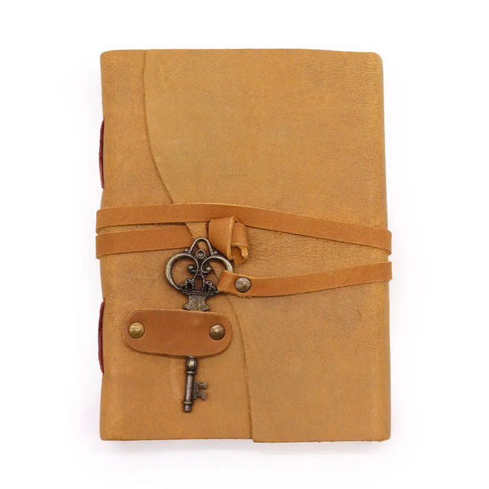 Oiled tan leather journal with a decorative key attached to its strap measures 7 by 5 inches