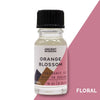 A clear glass bottle of orange blossom fragrance oil with a black cap and pink geometric label showing allergen declarations