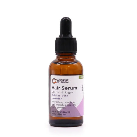 An amber glass bottle of organic hair serum with a black dropper cap and white label with purple accents
