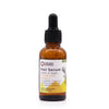 An amber glass bottle of organic hair serum with black dropper labeled ancient wisdom hair serum infused with rosemary