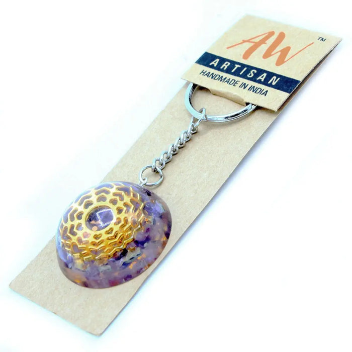 Orgonite power keyring made of purple and gold resin with a geometric pattern and an embedded amethyst stone