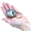 A circular orgonite power keyring with silver metal ring and resin design containing colorful chakra gemstones