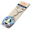 A circular translucent resin orgonite power keyring with colorful gemstones and a gold meditating buddha silhouette