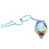 A colorful hexagonal resin orgonite power keyring with a silver hamsa hand and rainbow gemstones embedded