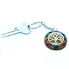 A circular multi-colored resin orgonite power keyring with a golden tree of life design and gemstones chakra details