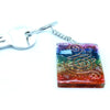 A square rainbow resin orgonite power keychain with crystals and copper wire swirls for home chakra protection