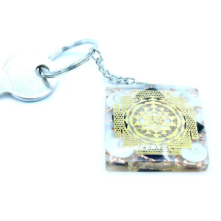 Clear resin orgonite power keyring with golden sri yantra design and copper white circular elements for home protection