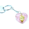 Orgonite power keyring with pink rose quartz heart, golden leaf pendant, and silver-toned metal components