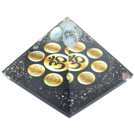Large black resin orgonite pyramid with gold chakra symbols om design and light blue white stones on top