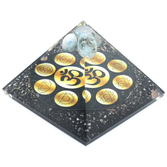 Large black resin orgonite pyramid with gold chakra symbols om design and light blue white stones on top