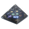A sleek black resin orgonite pyramid with golden flecks and a glowing colorful mystical reiki design