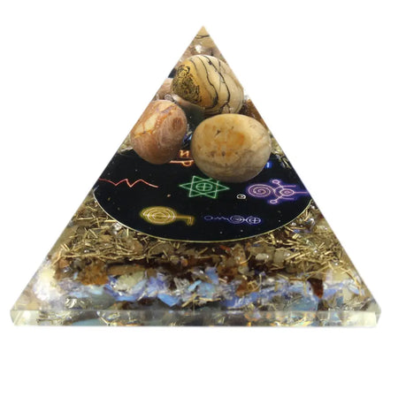 Large orgonite pyramid with clear resin, embedded stones, golden flakes, and black base with colorful mystical symbols