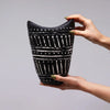 Black ceramic ornamental shaped vase with bold white geometric swirls and dotted accents in chocolate finish