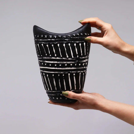 Black ceramic ornamental shaped vase with bold white geometric swirls and dotted accents in chocolate finish