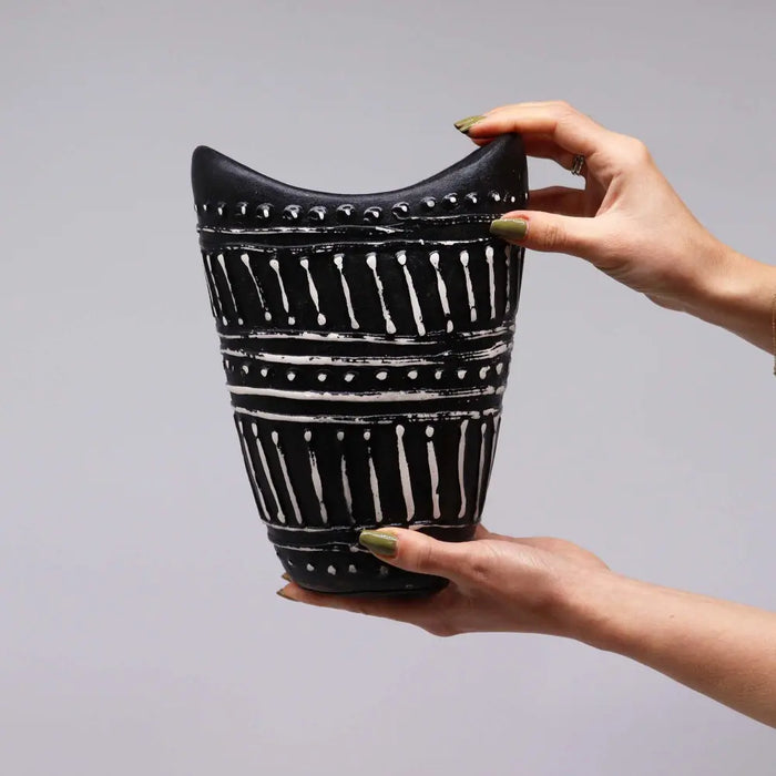 Black ceramic ornamental shaped vase with bold white geometric swirls and dotted accents in chocolate finish