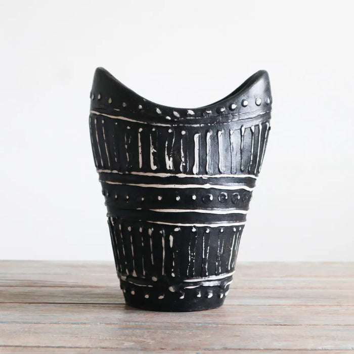 Ornamental shaped ceramic vase in chocolate black with white swirls and dotted geometric patterns