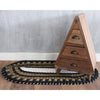 Triangular wooden dresser with three drawers and brass handles on a natural black and white oval-shaped seagrass rug