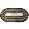 Oval-shaped seagrass rug with concentric black beige and white stripes made from natural fibers