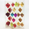 Pack of shiny heart-shaped mini baubles in red gold green blue purple and bronze with metallic caps