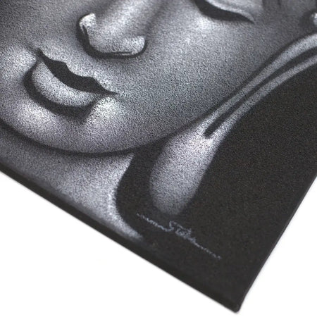Black canvas print of grey buddha face with sand finish featuring detailed monochrome design and subtle silver highlights