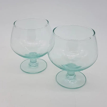 Pair of hand-blown recycled glass brandy glasses with subtle teal tint and rounded bowls 400ml capacity