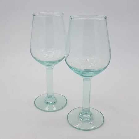 Two translucent light blue hand-blown recycled glass wine glasses with slender stems and circular bases 200ml capacity