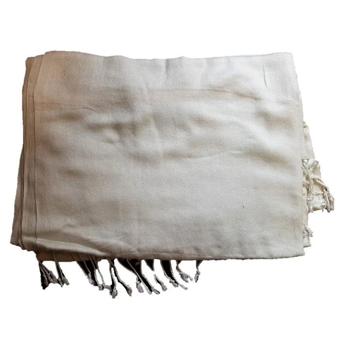 Beige woven textile blanket with fringed edges shown alongside a pale blue wool blend pashmina shawl
