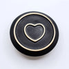 Black ceramic smudge holder with raised gold heart design for palo santo sticks and sage bundles use