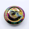 A metallic rainbow palo santo stick and smudge holder with a round iridescent fidget spinner design and heart center