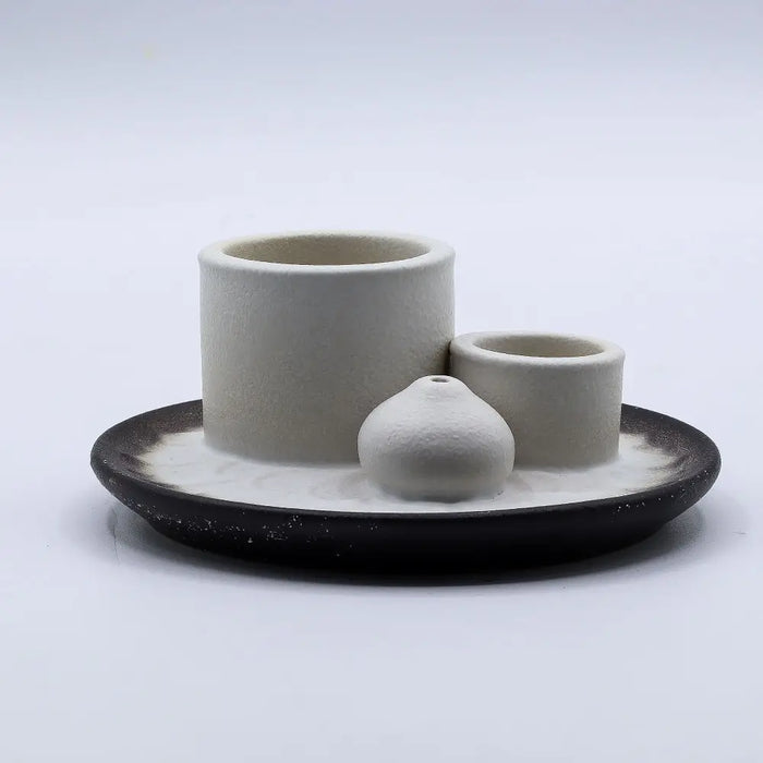 Minimalist white ceramic palo santo sticks and smudge holder set with two holders and pear-shaped vessel on speckled base