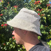 A light beige textured boho festival hat made of patched hemp and cotton with a worn fabric finish