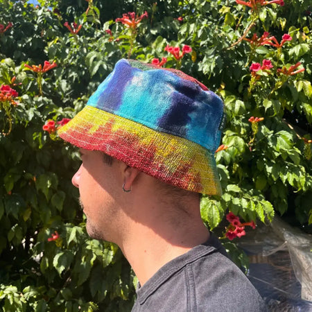 A vibrant tie-dye cotton boho festival hat with patched hemp and cotton woven fabric in blue teal yellow and red