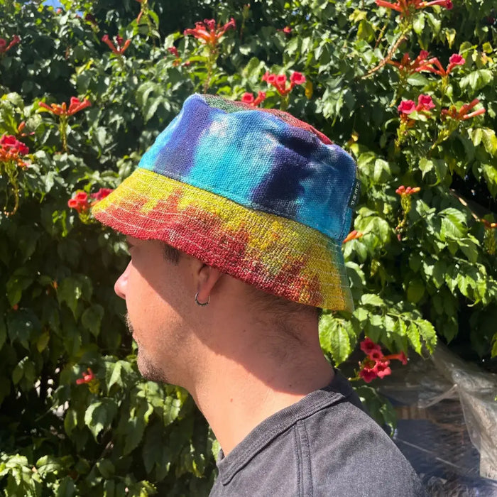 A vibrant tie-dye cotton boho festival hat with patched hemp and cotton woven fabric in blue teal yellow and red