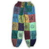 Colorful patchwork harem pants in green with embroidered mushrooms flowers and symbols on each panel in size s/m