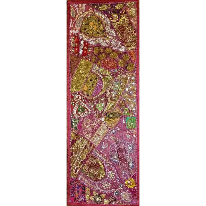 A patchwork wall hanging and table runner with vibrant paisley and floral embroidery in pink gold and purple with sparkle details