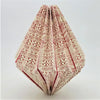 A cream paper geometric origami light shade with red tribal patterns designed as a short pendant light shade