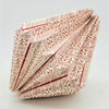 A cream-colored patterned origami light shade with red geometric designs folded into sharp creases for a short pendant