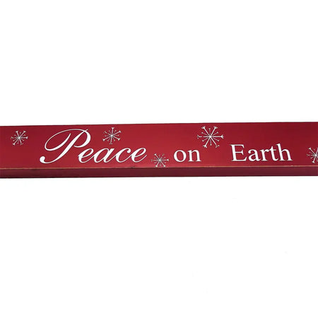 Red wooden free-standing wooden plaque with white cursive lettering peace on earth and snowflake designs