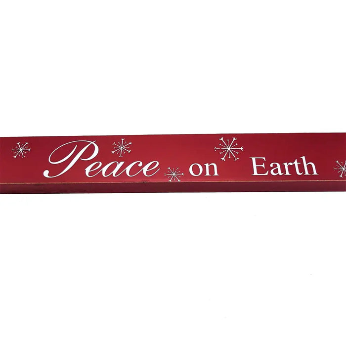 Red wooden free-standing wooden plaque with white cursive lettering peace on earth and snowflake designs