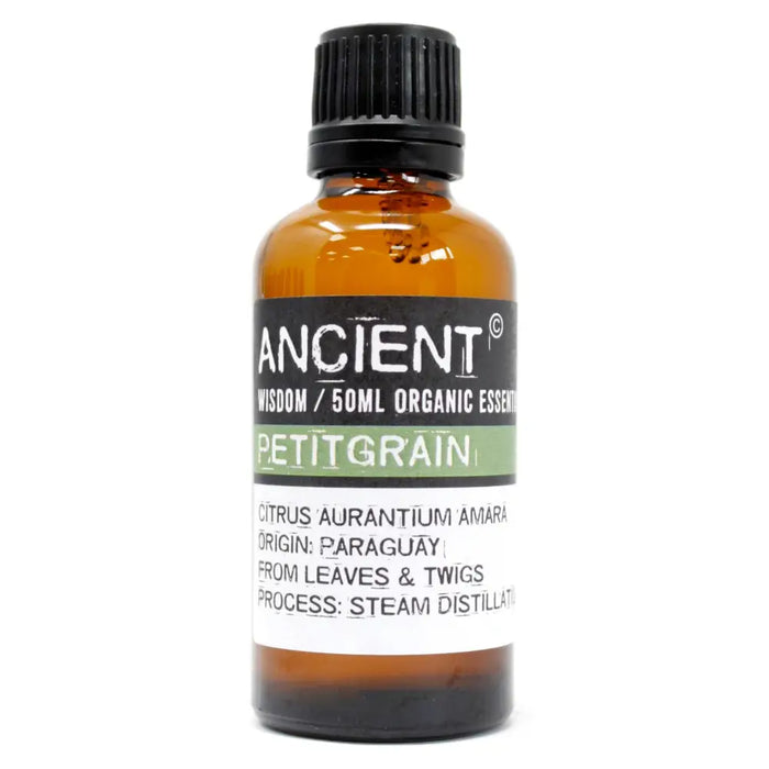 A 50ml amber glass bottle of ancient wisdom petitgrain essential oil with a black cap from paraguay